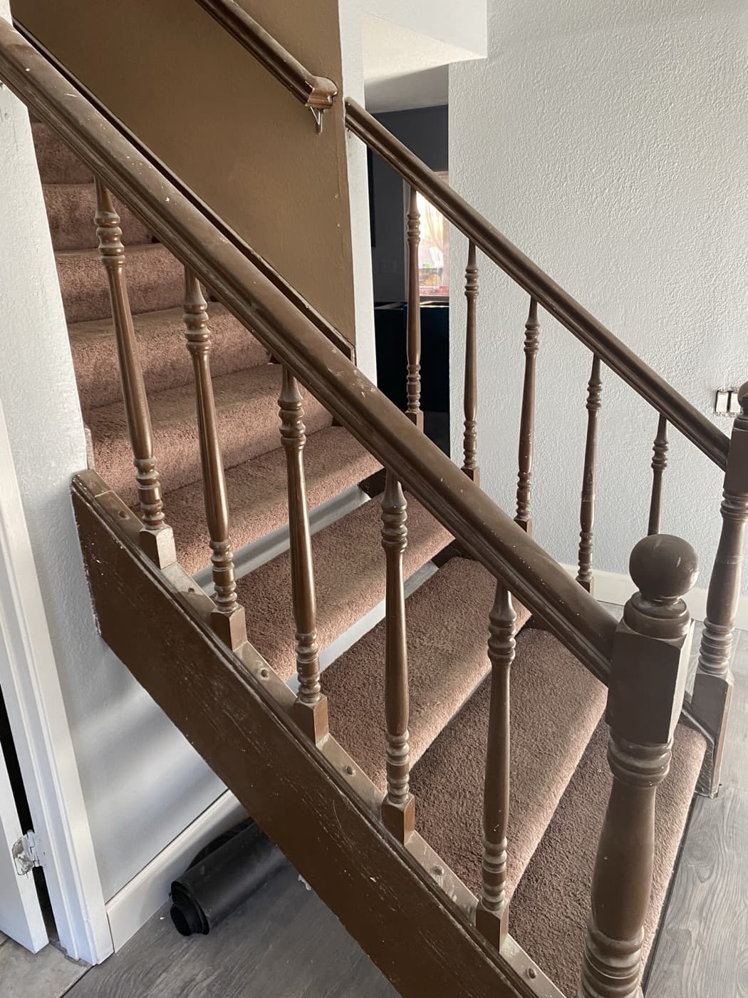 Worn carpeted staircase before remodel